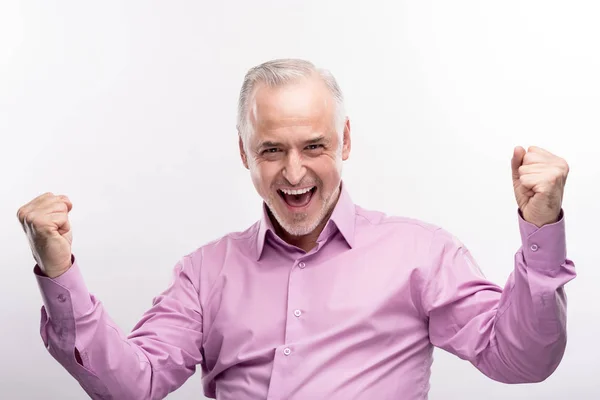 Happy grey-haired man doing fist pumps — Stock Photo, Image