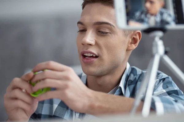 Joyful blogger making video about his bracelet — Stock Photo, Image