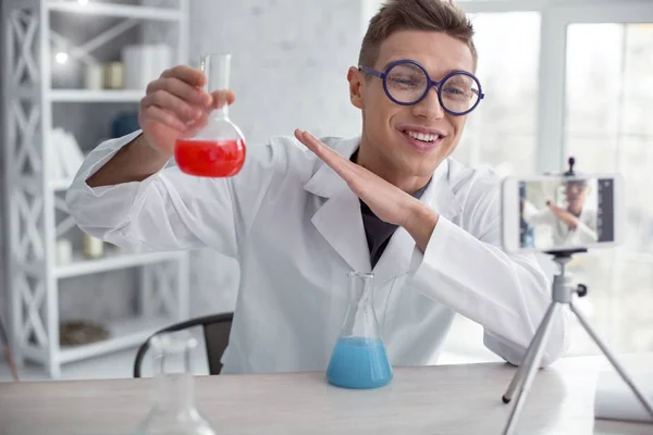 Cheerful vlogger doing an interesting experiment — Stock Photo, Image