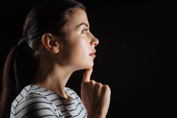 Thoughtful pretty woman touching to her chin looking aside. — Stock Photo, Image