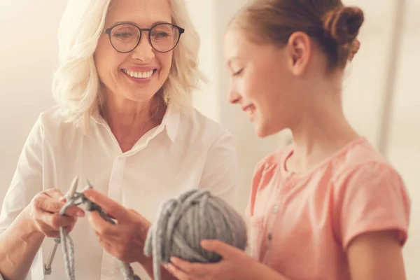 Happy delighted woman looking at her granddaughter — Stock Photo, Image