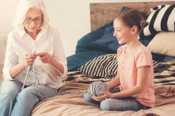 Positive cheerful girl looking at her grandmother — Stock Photo, Image
