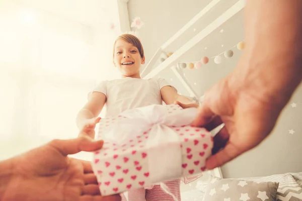 Nice happy girl receiving a present — Stock Photo, Image