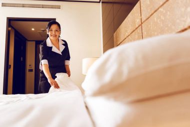 Smiling woman working as hotel maid clipart