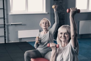 Dumbell ile çalışma dışarı iki üst düzey kadın