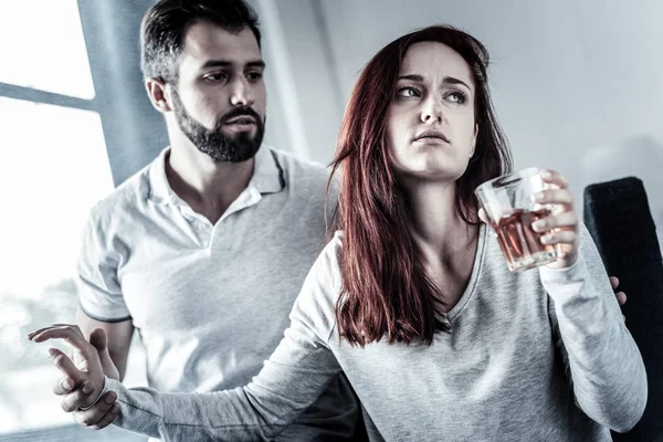 Stressful frustrated woman drinking and turning away from husband. — Stock Photo, Image