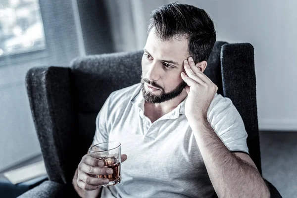 Deep unshaken man sitting and drinking. — Stock Photo, Image