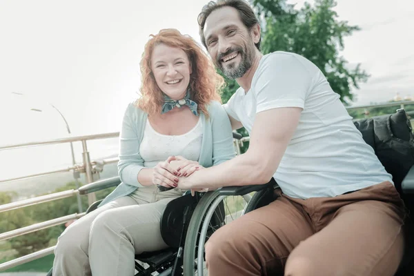 Joyful woman sitting near her man