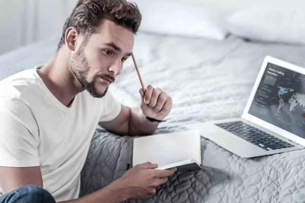 Nice thoughtful man touching his head with the pencil — Stock Photo, Image