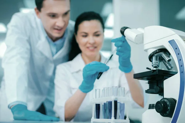 Positive delighted colleagues doing experiment — Stock Photo, Image