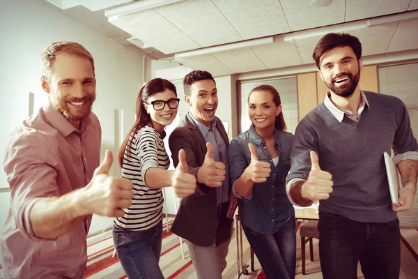 Positive happy people showing thumbs up gestures — Stock Photo, Image