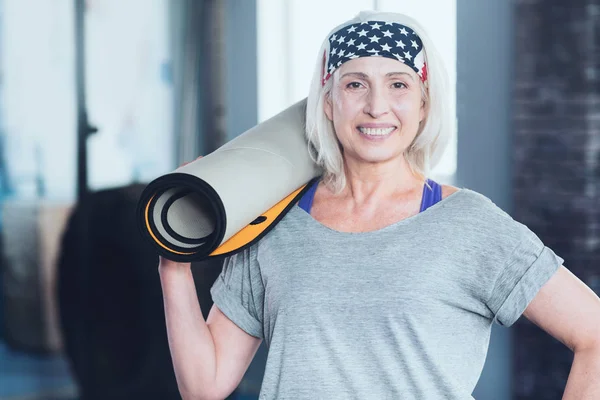 Beautiful senior lady with mat posing for camera — Stock Photo, Image