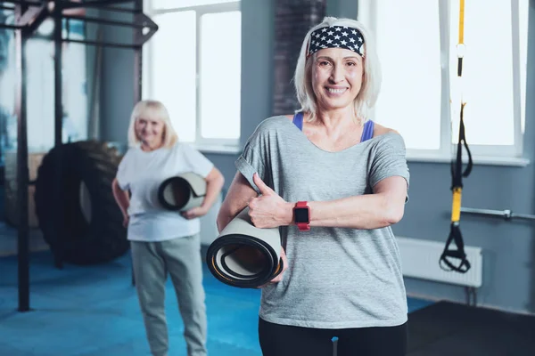 Fröhliche sportliche Frau zeigt beim Training Daumen nach oben — Stockfoto