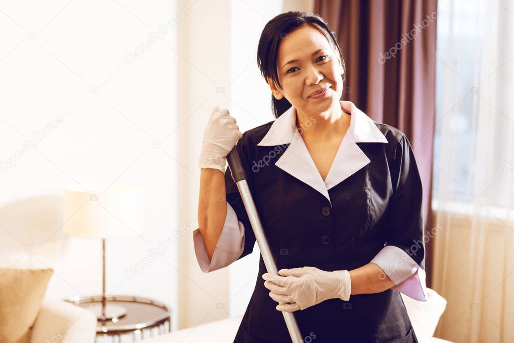 Positive delighted maid posing on camera