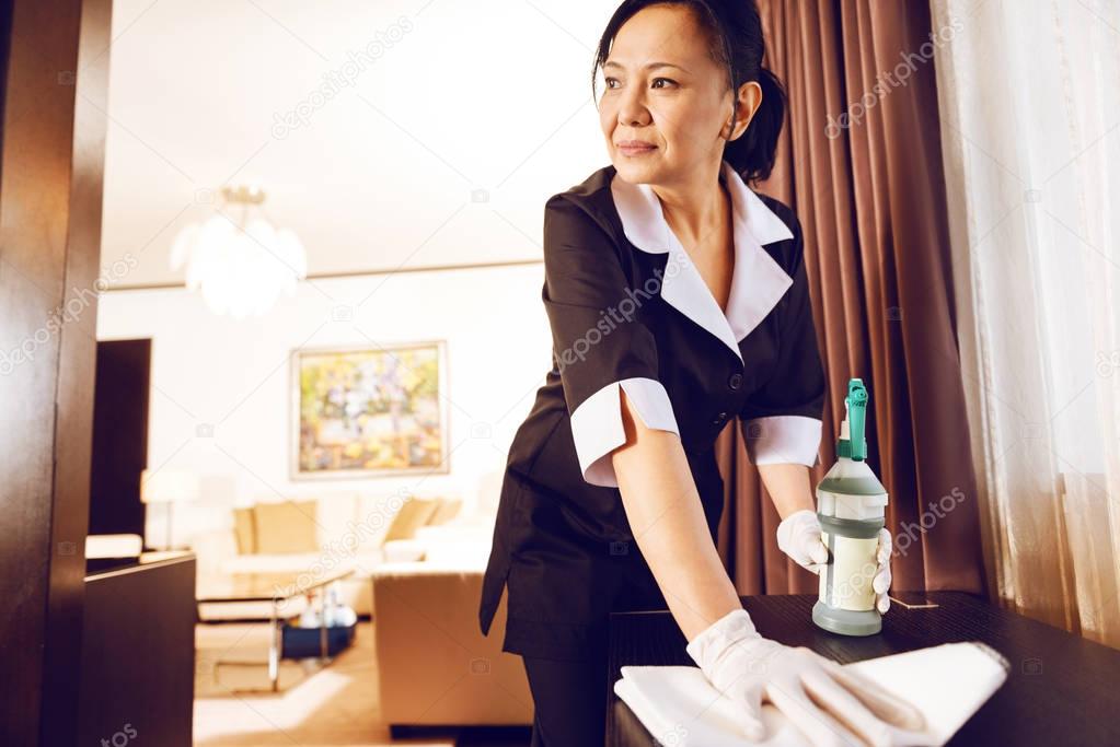 Positive delighted brunette working in hotel