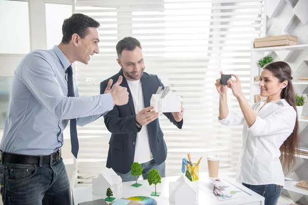 Cheerful architects taking photos in the office — Stock Photo, Image