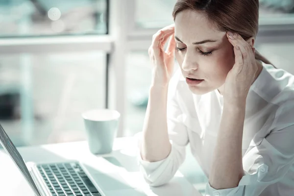 Exhausted loaded woman sitting and feeling bad herself. — Stock Photo, Image