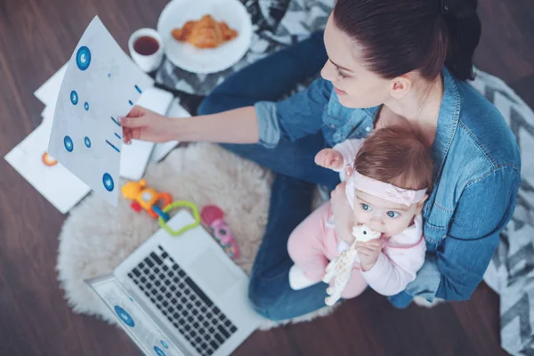 Delighted young mother enjoying her work — Stock Photo, Image