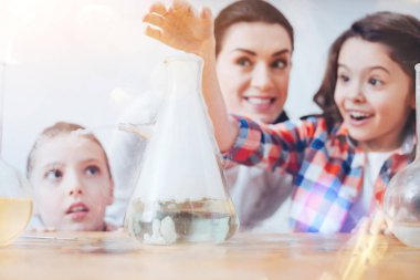 Scaled up shot of children having fun in chemistry lab clipart