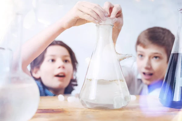 Close up of schoolboys during chemistry practical session — Stock Photo, Image