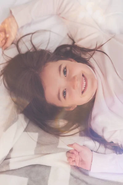 Positive charismatic girl resting in cozy bed — Stock Photo, Image