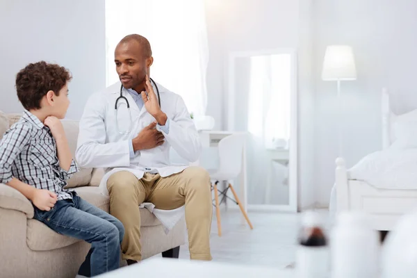 Successful male doctor sharing knowledge with boy — Stock Photo, Image