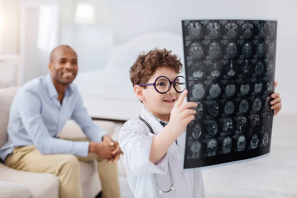 Smart pleasant boy examining brain imaging