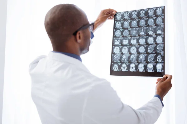 Médico masculino atraente avaliando imagens cerebrais — Fotografia de Stock