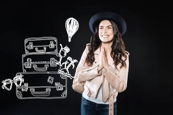 Optimistic person smiling and planning her holidays abroad — Stock Photo, Image