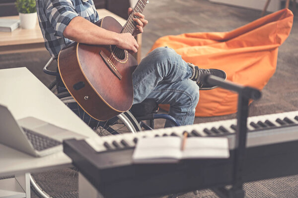 Invalid man playing the guitar