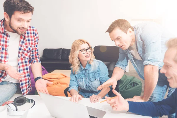 Positive colleagues using laptop in the office — Stock Photo, Image