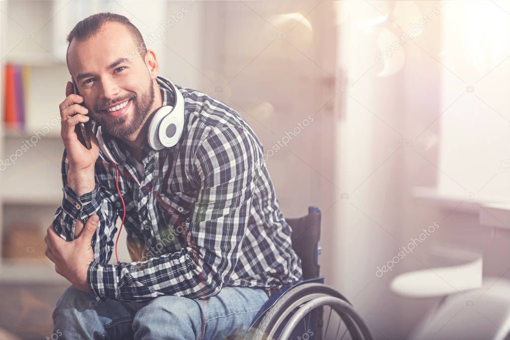 Smiling attractive man speaking on phone