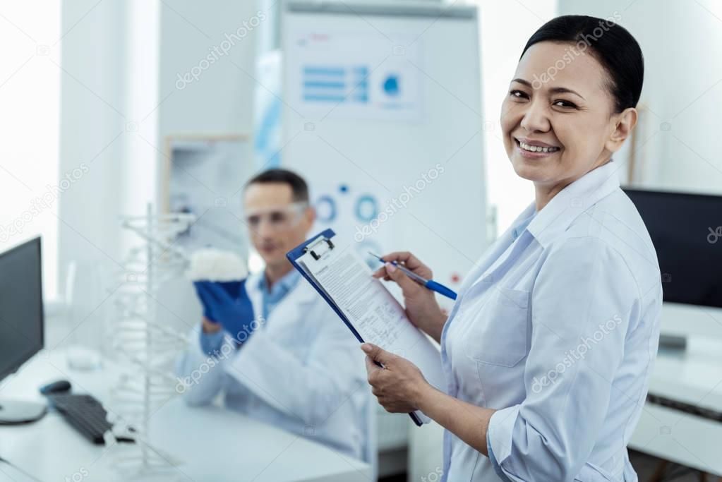 Content scientist taking notes of the results