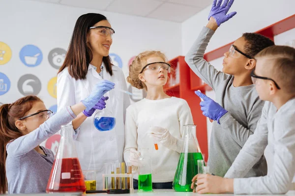 Pleasant boy asking his chemistry teacher a question — Stock Photo, Image