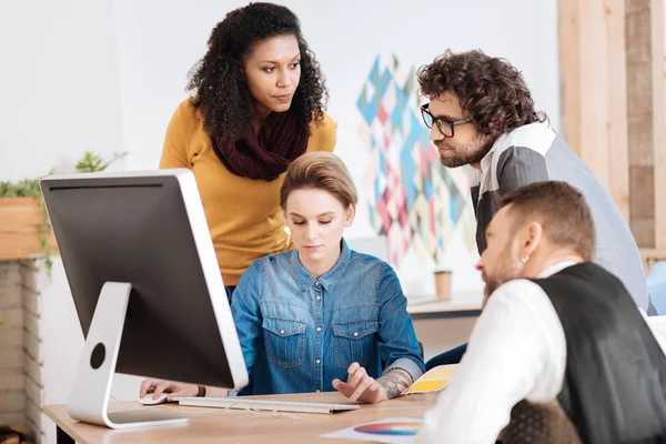 Determined young woman with her colleagues — Stock Photo, Image