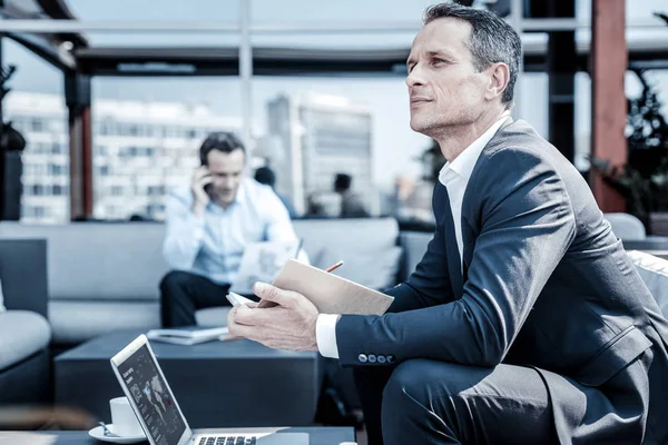 Pleasant thoughtful businessman thinking about his work — Stock Photo, Image