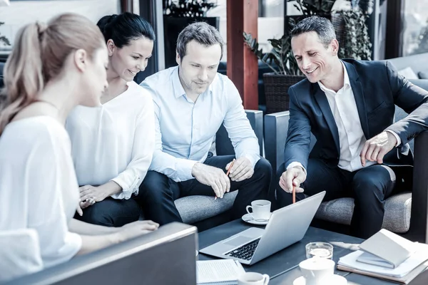 Cheerful handsome man talking to his colleagues — Stock Photo, Image