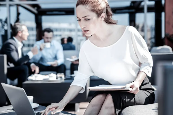 Nice serious businesswoman holding documents — Stock Photo, Image