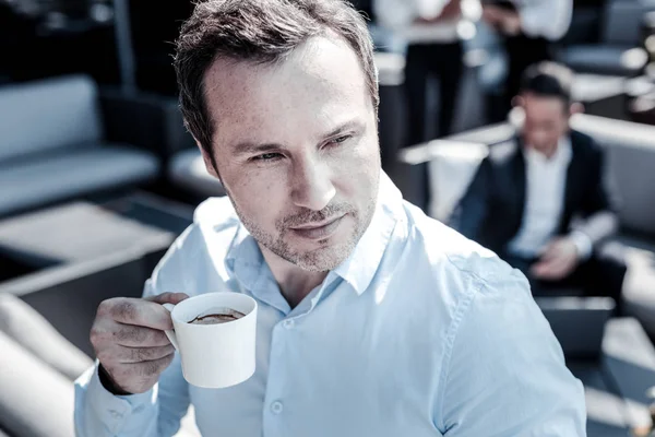 Serious nice businessman drinking espresso — Stock Photo, Image