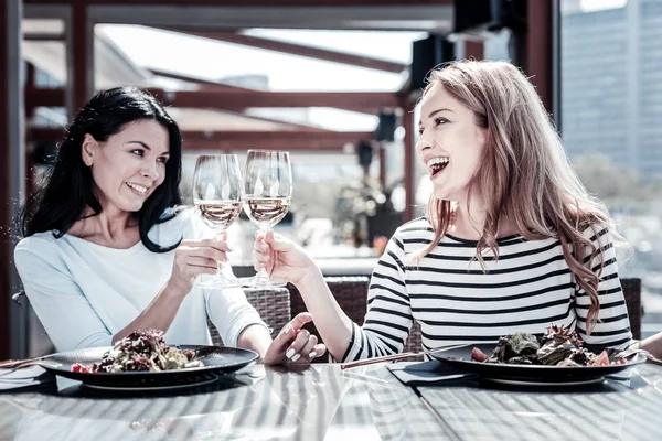 Positive nice women cheering with wine — Stock Photo, Image
