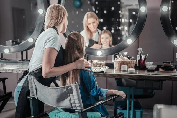 Geschickte Maskenbildnerin steht hinter ihrer Kundin — Stockfoto