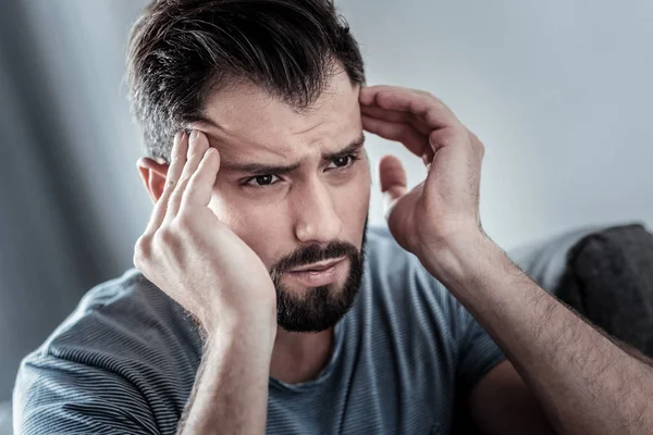 Depressed unhappy man having a headache — Stock Photo, Image