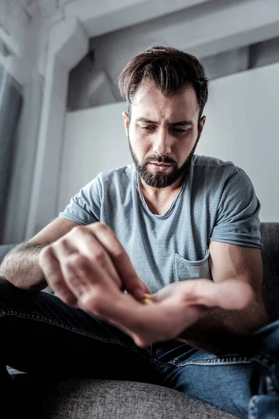 Unhappy sad man taking medicine — Stock Photo, Image