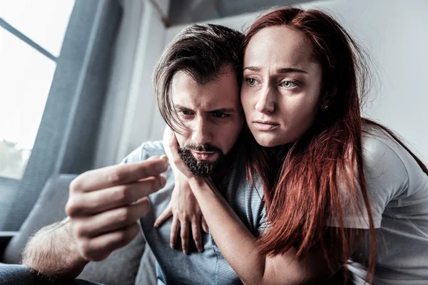 Unhappy young woman hugging her boyfriend — Stock Photo, Image