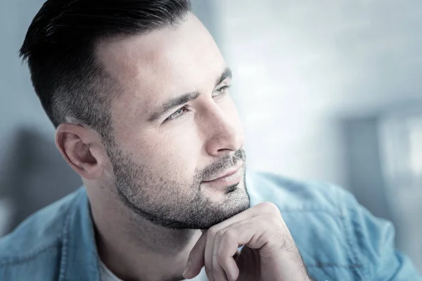 Nice thoughtful man holding his chin — Stock Photo, Image