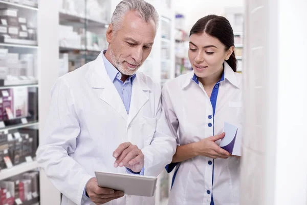 Experienced male pharmacist giving advising colleague — Stock Photo, Image