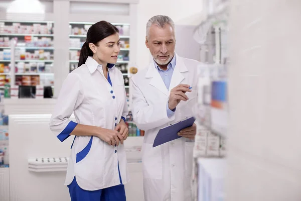 Attentive two pharmacists discussing organization moments — Stock Photo, Image