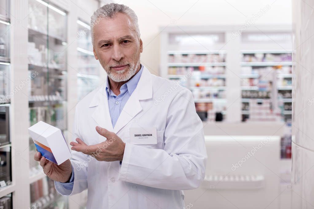 Successful male pharmacist taking new medication