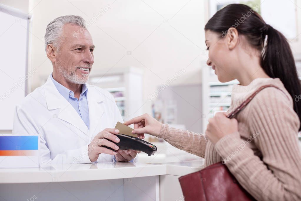 Brunette female client using credit card