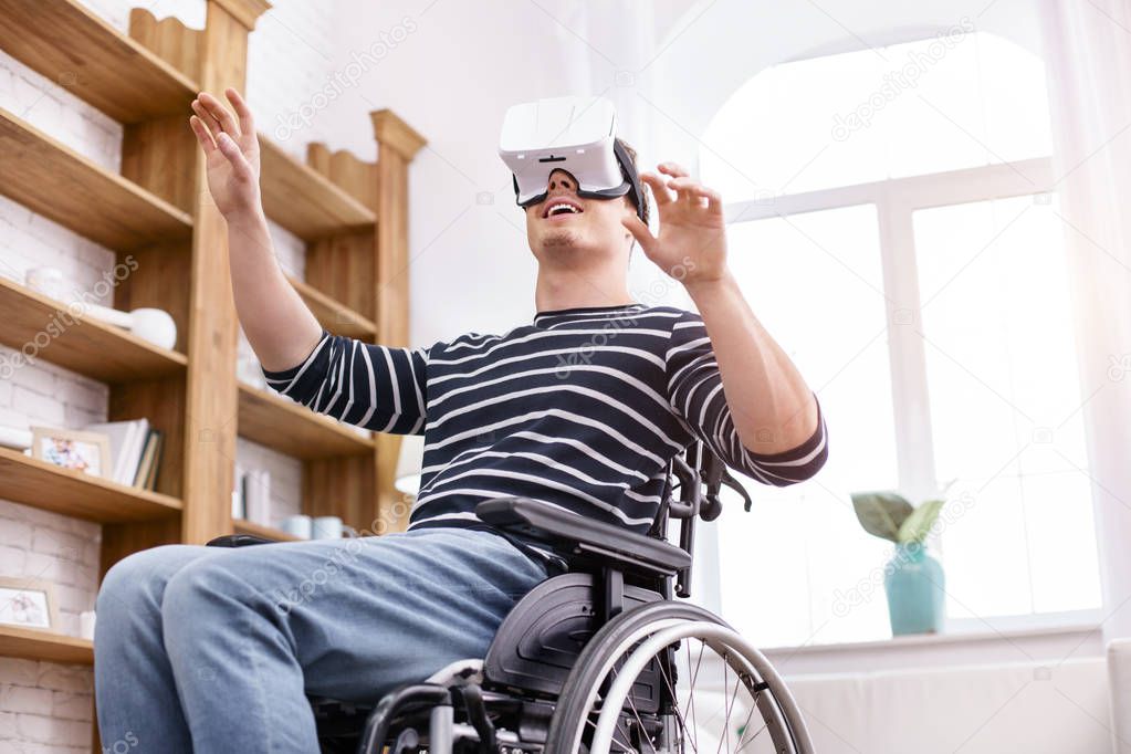 Happy disabled man being glad of his gadget